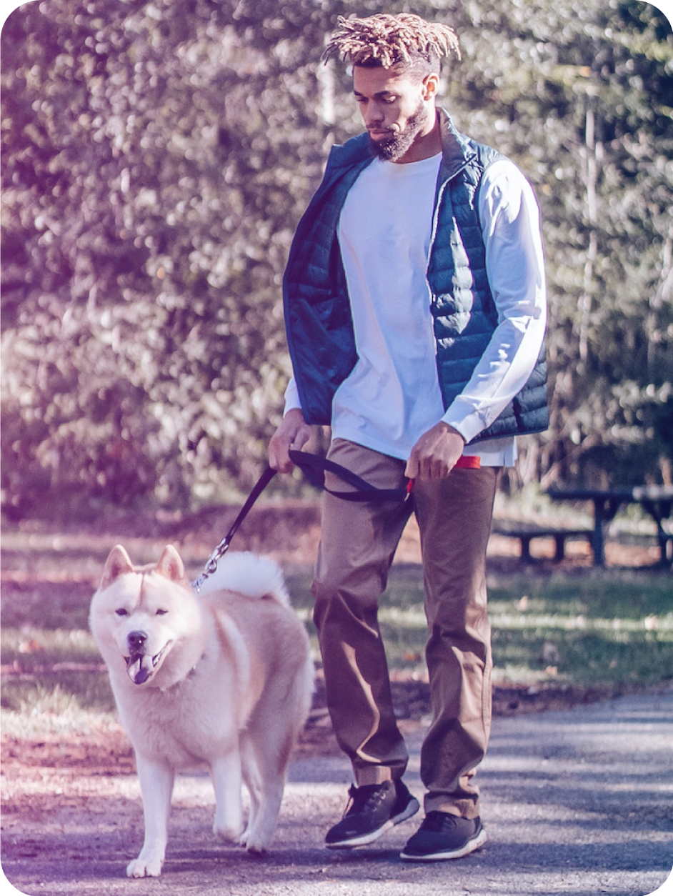 Image of male walking a dog
